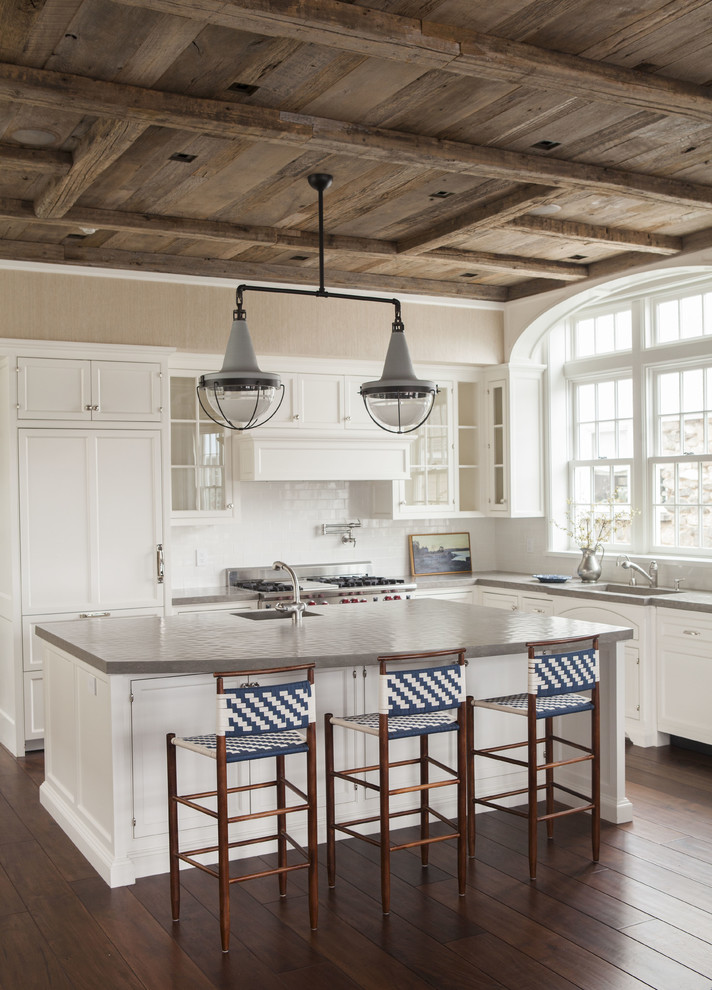 Kitchen - traditional dark wood floor and brown floor kitchen idea in Dallas with a single-bowl sink, beaded inset cabinets, white cabinets, limestone countertops, white backsplash, ceramic backsplash, stainless steel appliances, an island and gray countertops