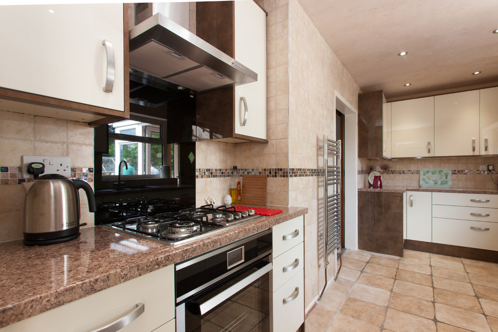 Photo of a medium sized classic galley enclosed kitchen in Other with beige splashback and no island.
