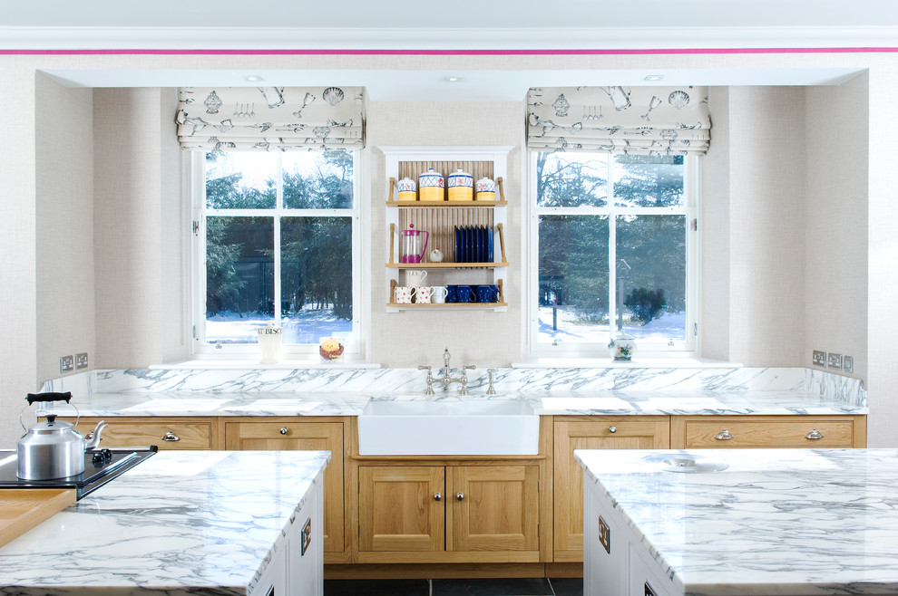 Huge elegant kitchen photo in Other with a farmhouse sink, shaker cabinets, light wood cabinets, marble countertops and two islands