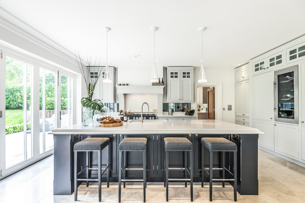 Large elegant l-shaped beige floor eat-in kitchen photo in Berkshire with a farmhouse sink, shaker cabinets, gray cabinets, an island, white countertops, white backsplash and paneled appliances