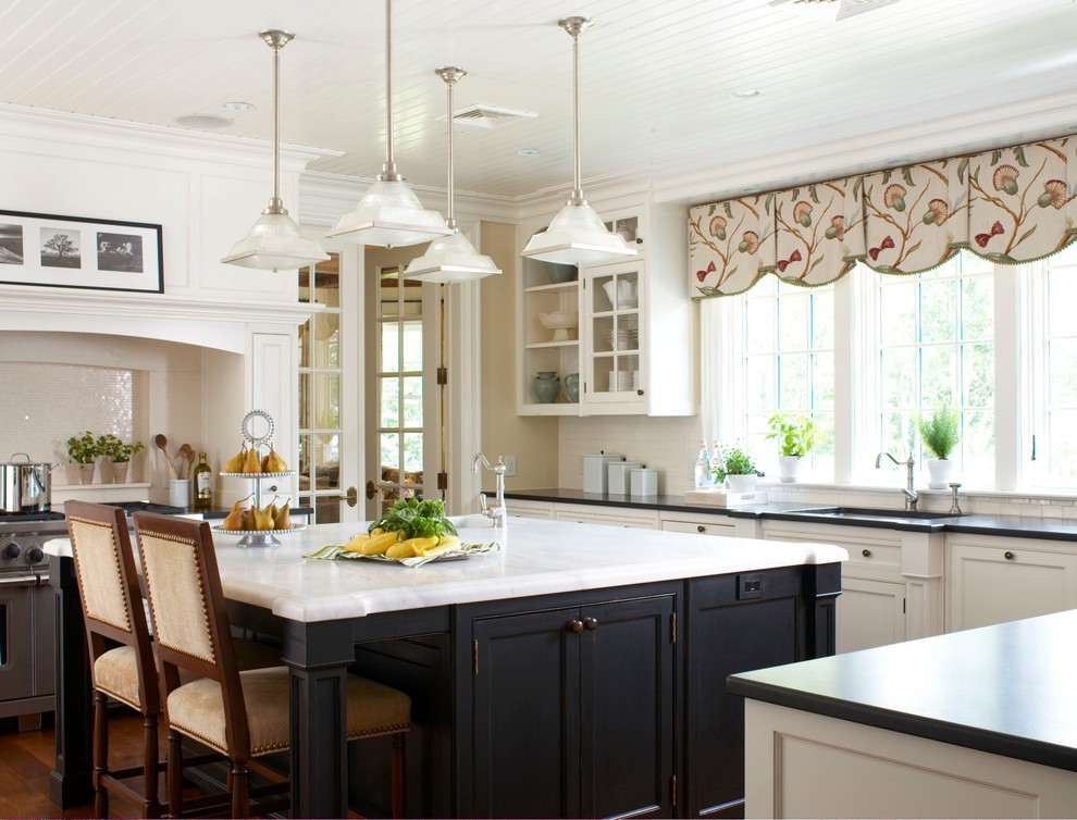 Inspiration for a timeless u-shaped kitchen remodel in New York with white cabinets and white backsplash