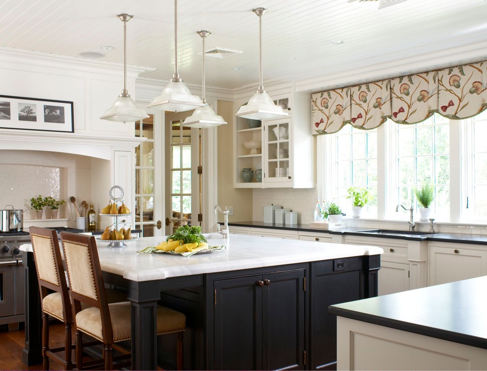 This is an example of a traditional u-shaped kitchen in New York with white cabinets and white splashback.