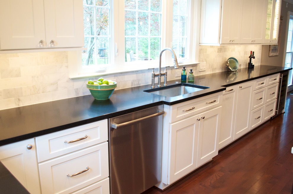 Inspiration for a large transitional u-shaped dark wood floor open concept kitchen remodel in DC Metro with an undermount sink, shaker cabinets, white cabinets, granite countertops, white backsplash, subway tile backsplash, stainless steel appliances and an island