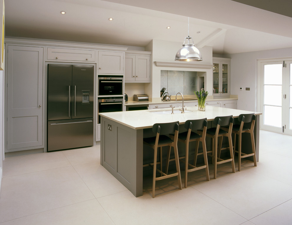 This is an example of a classic galley kitchen in Other with a submerged sink, shaker cabinets, grey cabinets and an island.