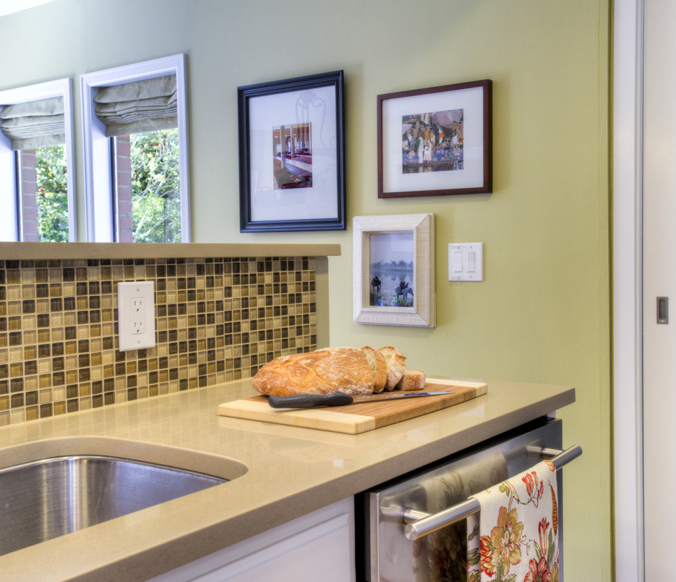 Example of a mid-sized classic u-shaped light wood floor and brown floor kitchen design in Seattle with recessed-panel cabinets, white cabinets, multicolored backsplash, mosaic tile backsplash, stainless steel appliances, an undermount sink and a peninsula