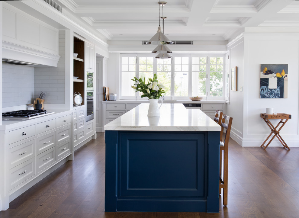 Exempel på ett klassiskt kök, med en dubbel diskho, skåp i shakerstil, blå skåp, marmorbänkskiva, stänkskydd i tunnelbanekakel, rostfria vitvaror och en köksö