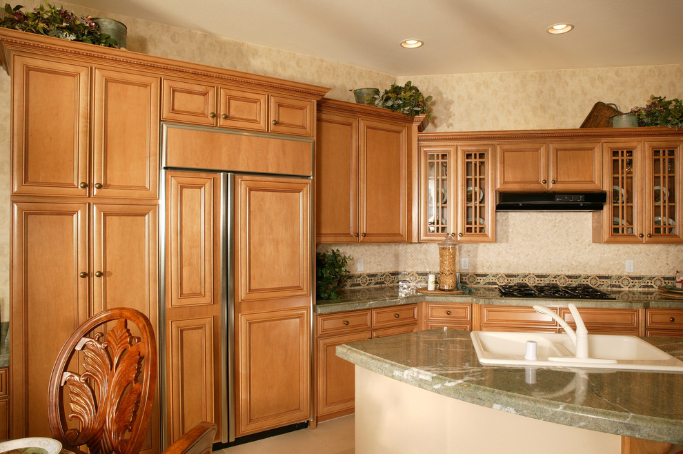 Inspiration for a timeless l-shaped eat-in kitchen remodel in Salt Lake City with an undermount sink, recessed-panel cabinets, medium tone wood cabinets, granite countertops, multicolored backsplash and paneled appliances