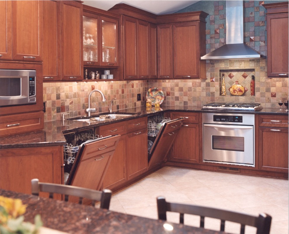 Example of a transitional kitchen design in Chicago with a triple-bowl sink, recessed-panel cabinets, granite countertops and paneled appliances