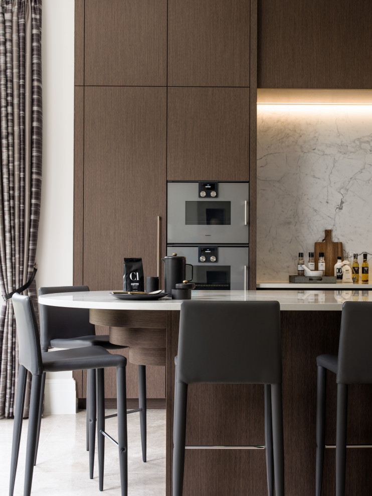 Large trendy kitchen photo in Surrey with flat-panel cabinets, dark wood cabinets, an island and white countertops