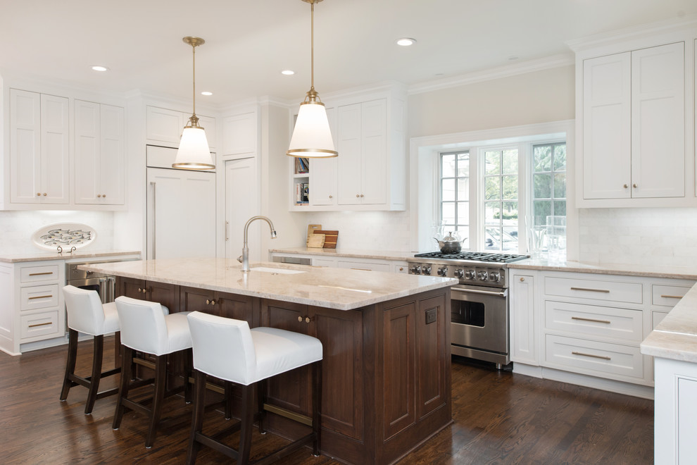 Inspiration for a classic u-shaped kitchen in Kansas City with a submerged sink, beaded cabinets, white cabinets, white splashback, stainless steel appliances, dark hardwood flooring, an island and beige worktops.