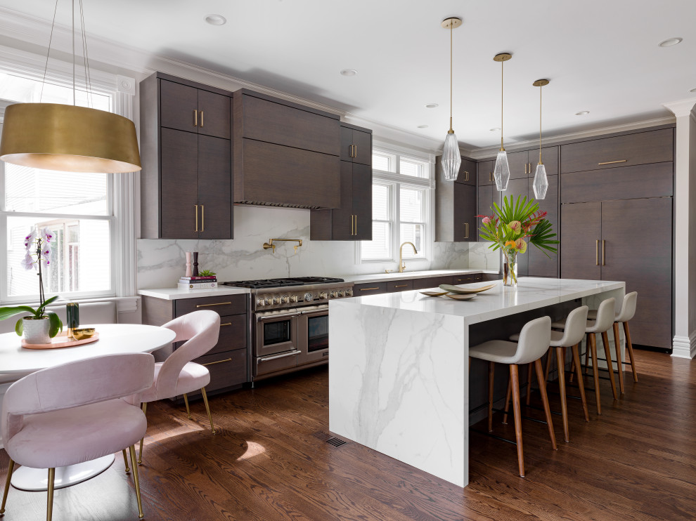 Large transitional l-shaped medium tone wood floor and brown floor eat-in kitchen photo in Chicago with an undermount sink, flat-panel cabinets, dark wood cabinets, white backsplash, marble backsplash, paneled appliances, an island and white countertops