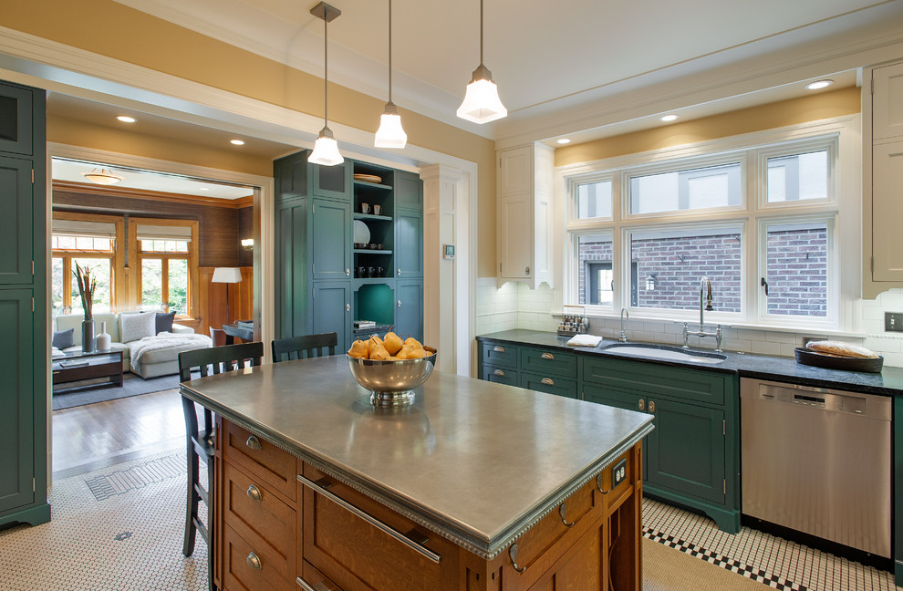 Inspiration for a large timeless u-shaped enclosed kitchen remodel in Seattle with stainless steel appliances, white backsplash, an island, a double-bowl sink, glass-front cabinets, blue cabinets, solid surface countertops and subway tile backsplash