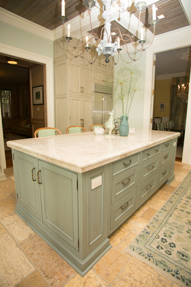 Photo of a medium sized traditional enclosed kitchen in New Orleans with a belfast sink, recessed-panel cabinets, beige cabinets, stainless steel appliances and an island.