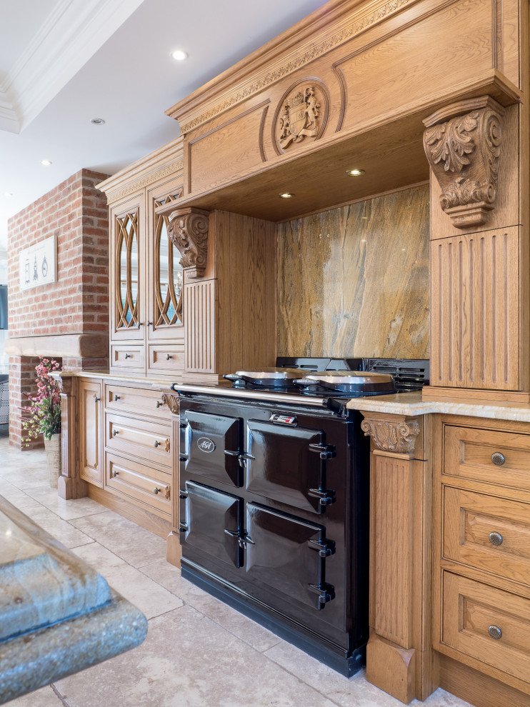 Example of a large ornate kitchen design in Essex with an island