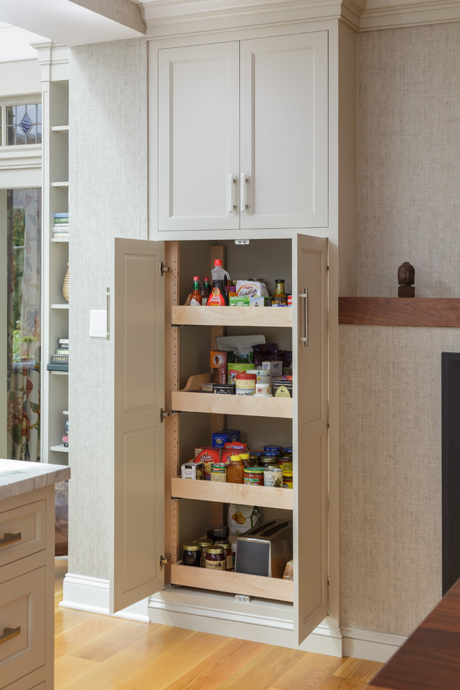 Enclosed kitchen - large traditional u-shaped light wood floor and beige floor enclosed kitchen idea in Philadelphia with an undermount sink, recessed-panel cabinets, white cabinets, marble countertops, white backsplash, marble backsplash, paneled appliances and two islands