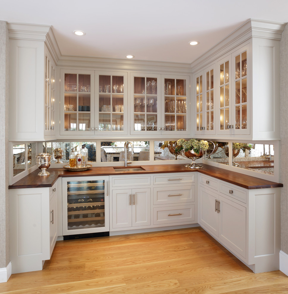 Enclosed kitchen - large traditional u-shaped light wood floor and beige floor enclosed kitchen idea in Philadelphia with an undermount sink, recessed-panel cabinets, white cabinets, marble countertops, white backsplash, marble backsplash, paneled appliances and two islands