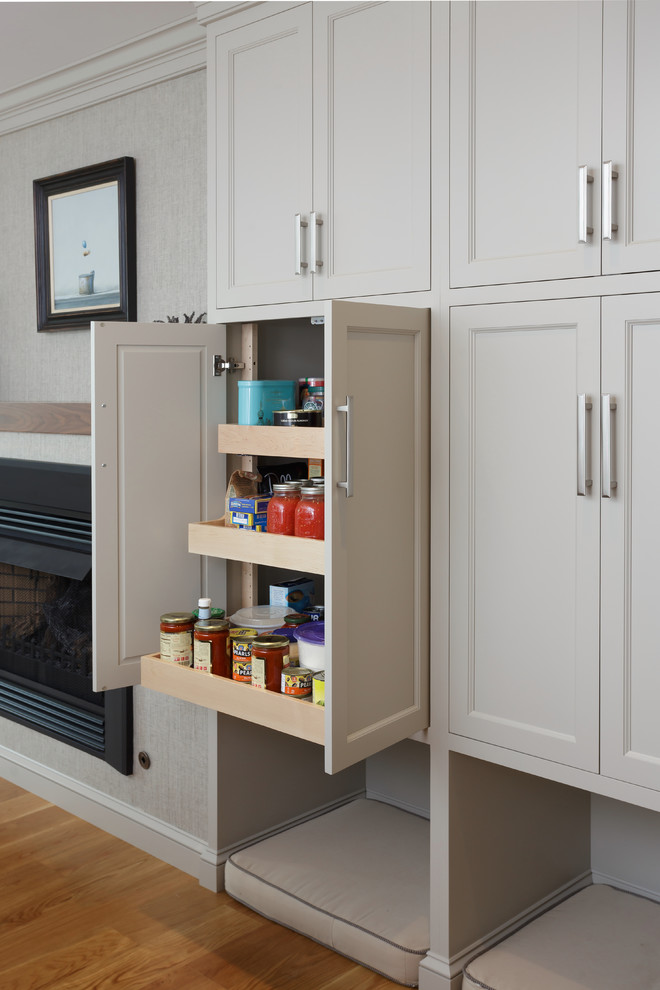 Inspiration for a large timeless u-shaped light wood floor and beige floor enclosed kitchen remodel in Philadelphia with an undermount sink, recessed-panel cabinets, white cabinets, marble countertops, white backsplash, marble backsplash, paneled appliances and two islands