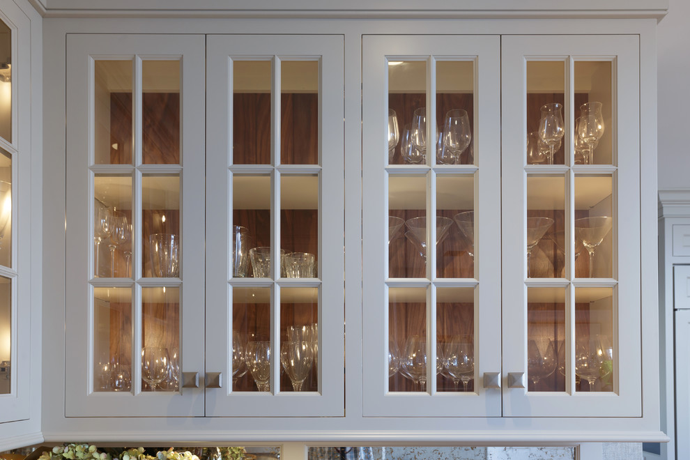 Example of a large classic u-shaped light wood floor and beige floor enclosed kitchen design in Philadelphia with an undermount sink, recessed-panel cabinets, white cabinets, marble countertops, white backsplash, marble backsplash, paneled appliances and two islands