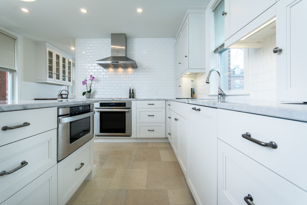 Example of a mid-sized transitional l-shaped cement tile floor eat-in kitchen design in Toronto with an undermount sink, shaker cabinets, white cabinets, marble countertops, white backsplash, subway tile backsplash, stainless steel appliances and an island