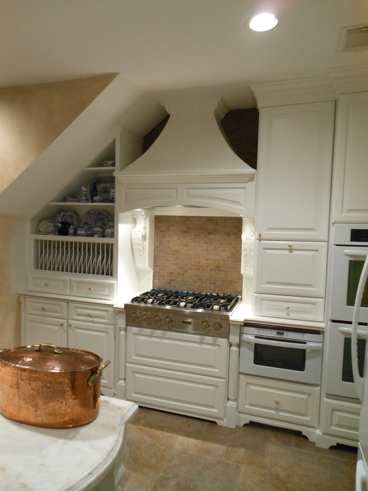 Пример оригинального дизайна: п-образная кухня в классическом стиле с обеденным столом, накладной мойкой, белыми фасадами, столешницей из акрилового камня, коричневым фартуком, фартуком из каменной плитки и белой техникой