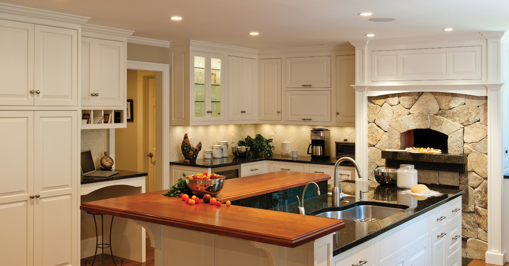 This is an example of a traditional kitchen in Burlington with white cabinets.
