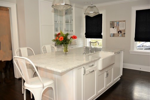 Eat-in kitchen - large transitional dark wood floor eat-in kitchen idea in New York with a farmhouse sink, recessed-panel cabinets, white cabinets, marble countertops, white backsplash, mosaic tile backsplash, white appliances and an island