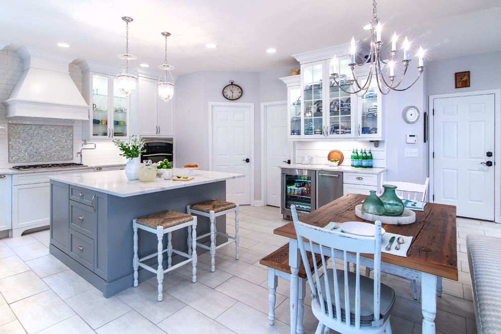 Inspiration for a mid-sized country l-shaped white floor eat-in kitchen remodel in Charlotte with a farmhouse sink, beaded inset cabinets, white cabinets, white backsplash, subway tile backsplash, stainless steel appliances, an island and white countertops