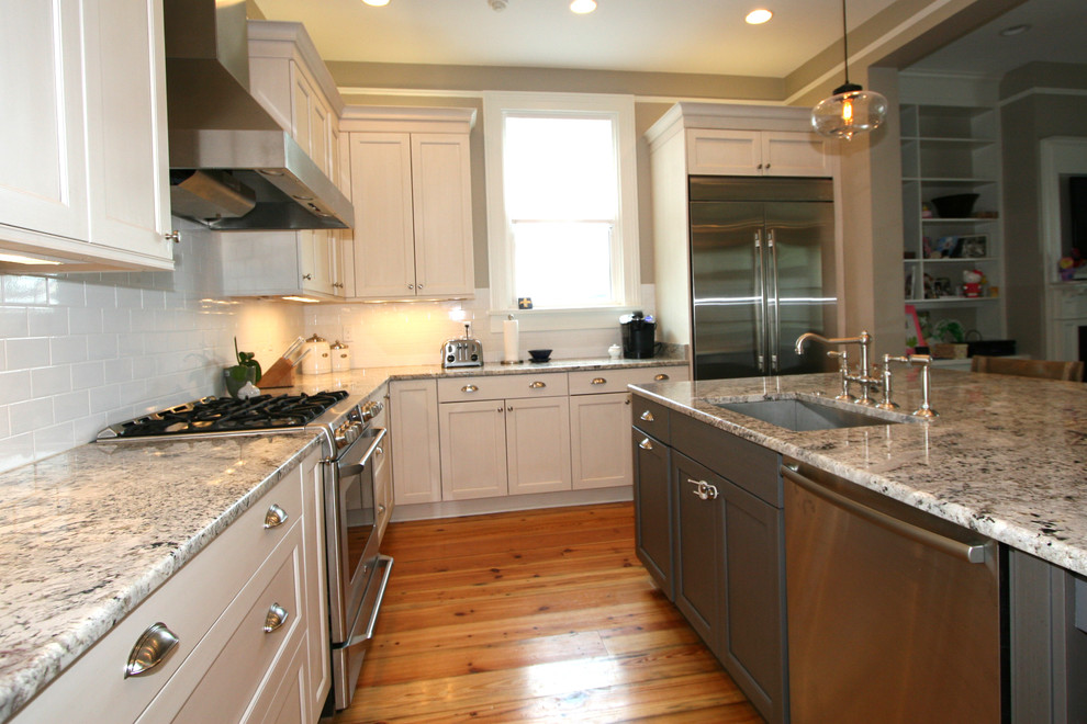 Classically Inspired Kitchen with Stainless Chimney Hood and Pantry