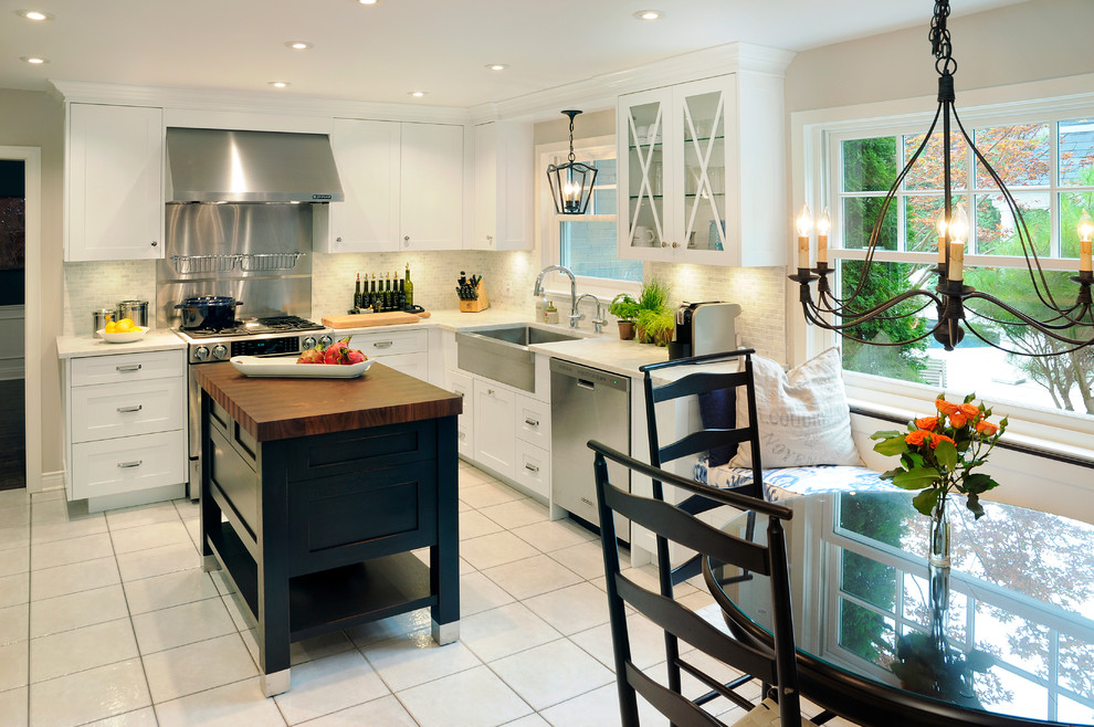 Exempel på ett mellanstort klassiskt kök, med en rustik diskho, skåp i shakerstil, vita skåp, marmorbänkskiva, vitt stänkskydd, stänkskydd i tunnelbanekakel, rostfria vitvaror och en köksö