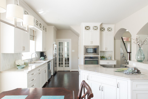 Bright kitchen with white shaker-style RTA Cabinet Trends, quartz countertops, and built-in microwave for a clean modern look.