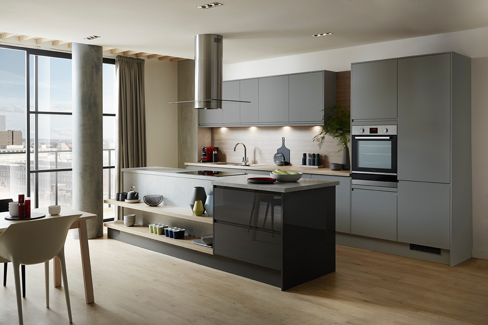 Medium sized contemporary single-wall open plan kitchen in Other with an integrated sink, flat-panel cabinets, grey cabinets, integrated appliances and an island.