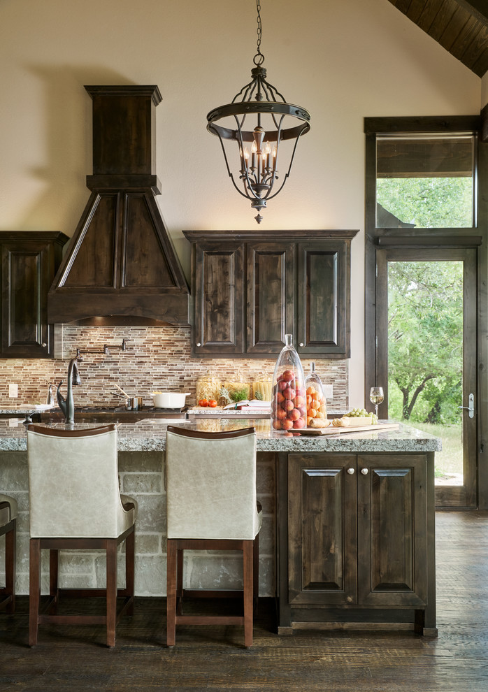 Exempel på ett stort klassiskt kök, med en rustik diskho, luckor med upphöjd panel, skåp i mörkt trä, granitbänkskiva, flerfärgad stänkskydd, stänkskydd i glaskakel, rostfria vitvaror, mörkt trägolv, en köksö och brunt golv