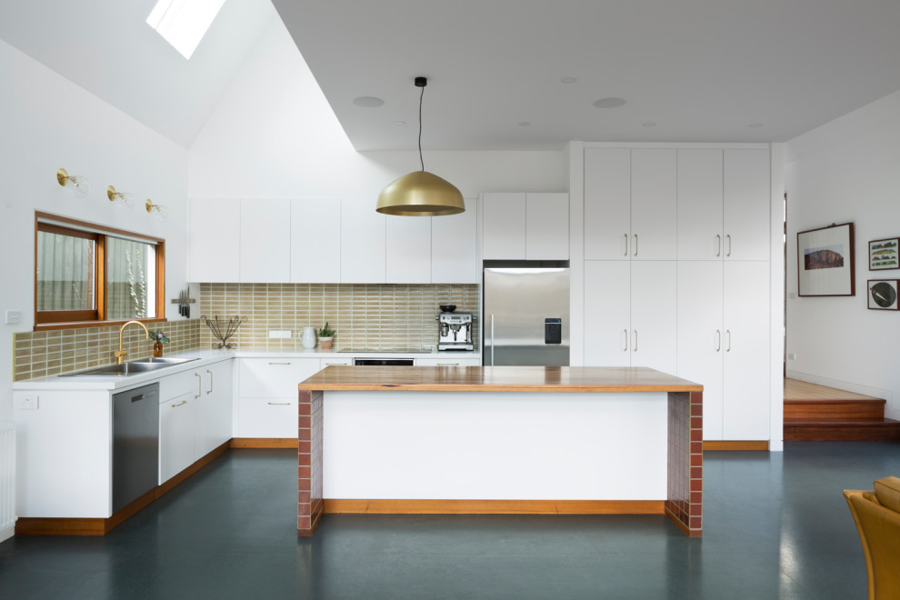 Mid-sized trendy l-shaped cork floor, green floor and vaulted ceiling open concept kitchen photo in Melbourne with an integrated sink, flat-panel cabinets, white cabinets, quartz countertops, ceramic backsplash, stainless steel appliances, an island and white countertops