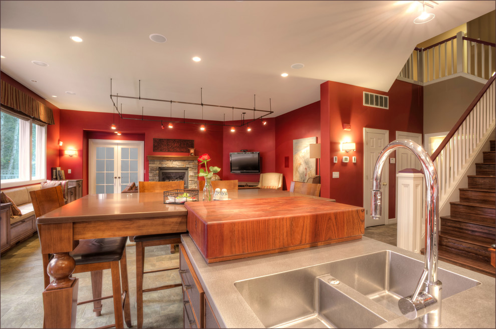Inspiration for a large eclectic u-shaped travertine floor eat-in kitchen remodel in Seattle with a drop-in sink, recessed-panel cabinets, dark wood cabinets, granite countertops, red backsplash, stainless steel appliances and an island