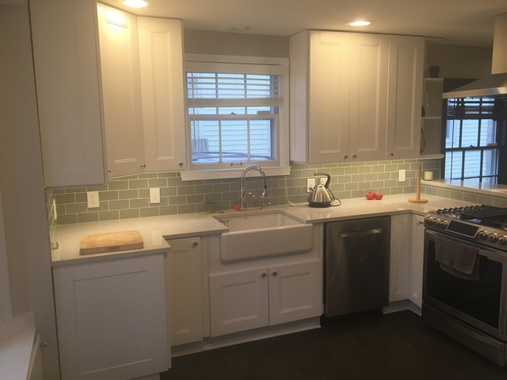 This is an example of a medium sized classic single-wall kitchen/diner in Columbus with a built-in sink, recessed-panel cabinets, white cabinets, granite worktops, green splashback, glass tiled splashback, stainless steel appliances, dark hardwood flooring and no island.