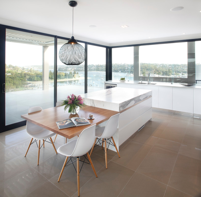 This is an example of a medium sized modern l-shaped kitchen in Sydney with a submerged sink, flat-panel cabinets, black cabinets, marble worktops, metallic splashback, glass sheet splashback, stainless steel appliances, porcelain flooring and an island.