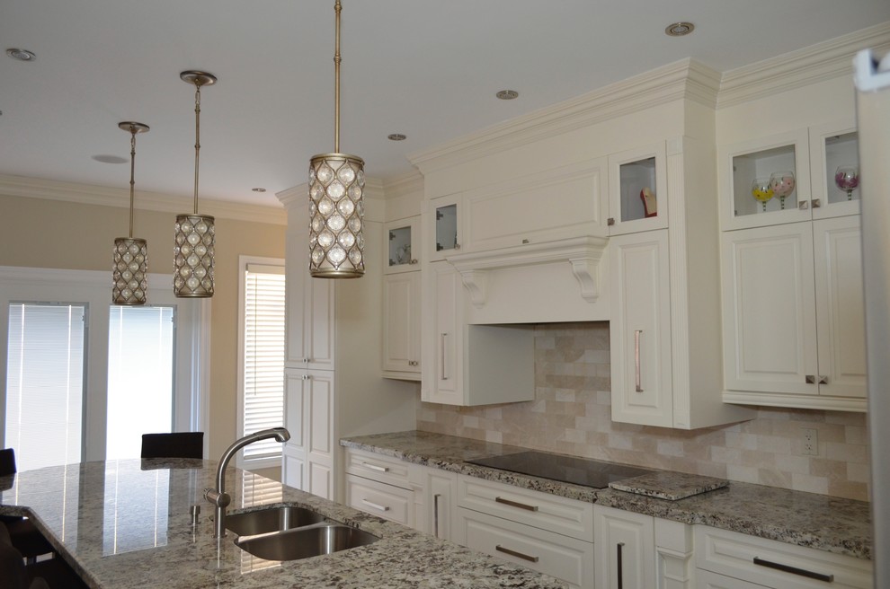 This is an example of a medium sized classic l-shaped enclosed kitchen in Toronto with a submerged sink, raised-panel cabinets, white cabinets, granite worktops, beige splashback, stainless steel appliances, porcelain flooring and an island.