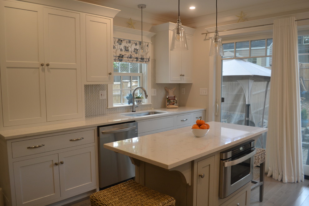 Inspiration for a small coastal u-shaped light wood floor and gray floor eat-in kitchen remodel in Boston with a single-bowl sink, shaker cabinets, white cabinets, granite countertops, multicolored backsplash, marble backsplash, stainless steel appliances, an island and white countertops