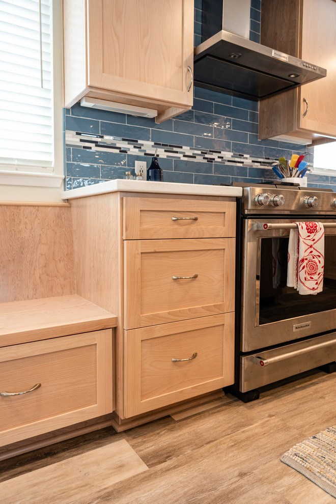 Mid-sized beach style l-shaped laminate floor and beige floor eat-in kitchen photo in San Luis Obispo with a drop-in sink, shaker cabinets, light wood cabinets, quartz countertops, blue backsplash, ceramic backsplash, stainless steel appliances, an island and multicolored countertops