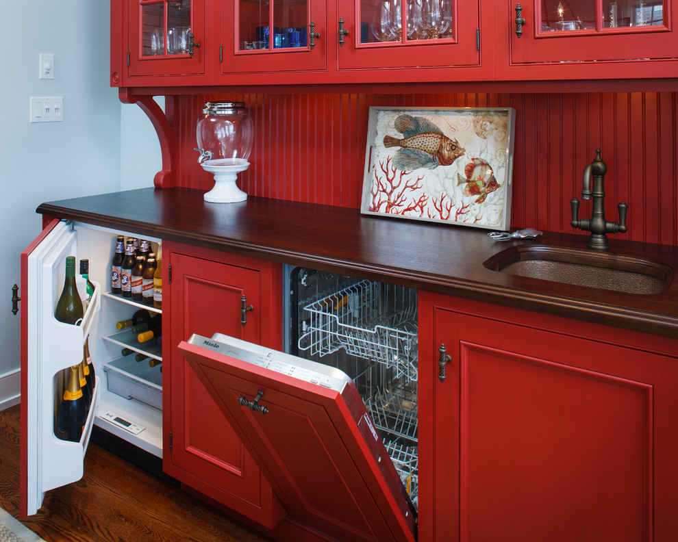 Inspiration for a coastal kitchen remodel in New York with an undermount sink, recessed-panel cabinets, red cabinets, wood countertops, red backsplash and paneled appliances