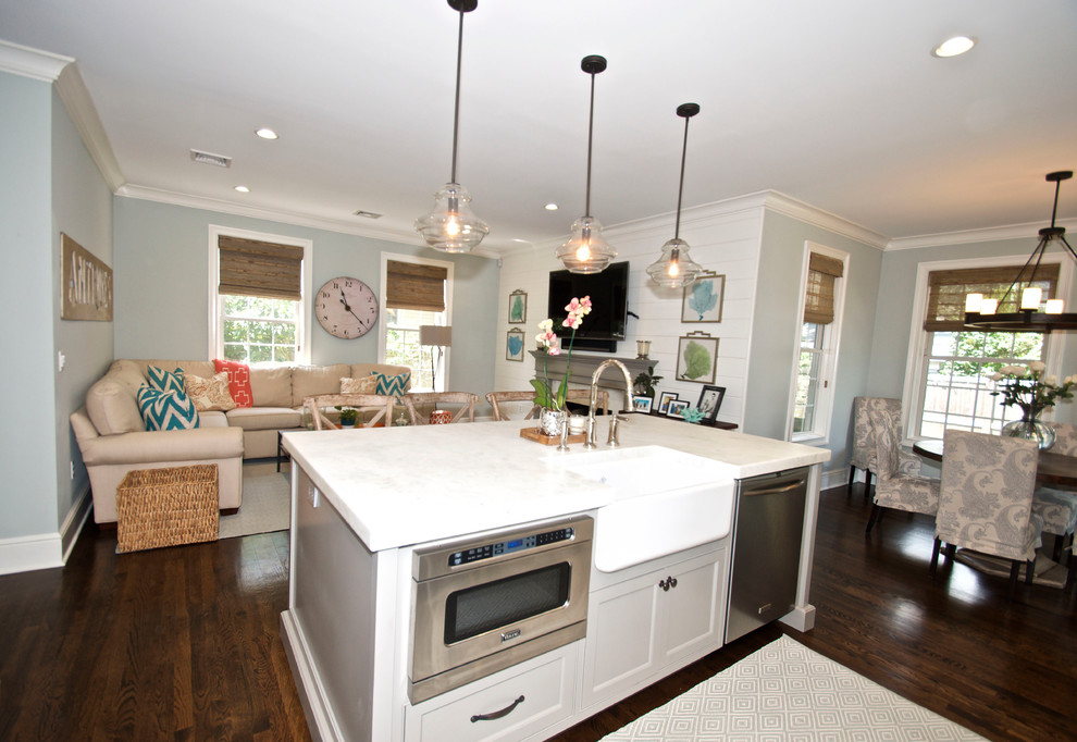 Mid-sized beach style l-shaped dark wood floor open concept kitchen photo in New York with a farmhouse sink, recessed-panel cabinets, gray cabinets, granite countertops, multicolored backsplash, glass tile backsplash, stainless steel appliances and an island