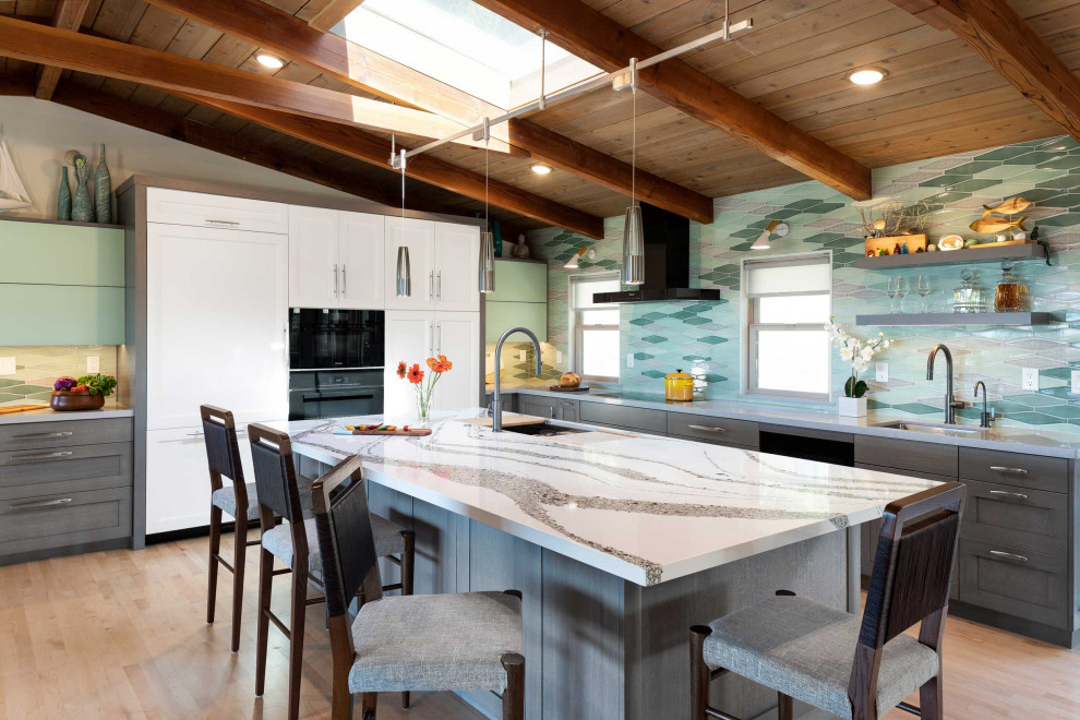 Bild på ett mellanstort 60 tals vit vitt kök, med en undermonterad diskho, luckor med infälld panel, grå skåp, bänkskiva i kvarts, grönt stänkskydd, stänkskydd i keramik, integrerade vitvaror, ljust trägolv, en köksö och gult golv
