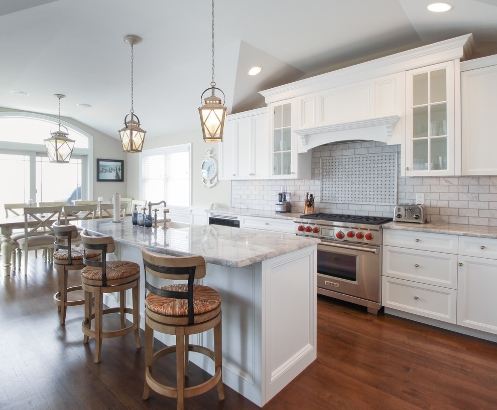 Inspiration for a large coastal eat-in kitchen remodel in New York with marble countertops, gray backsplash, stainless steel appliances and an island