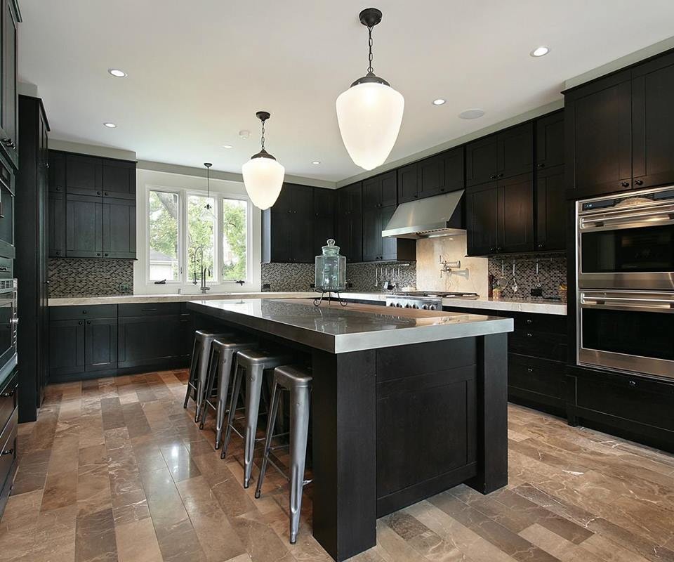 This is an example of a medium sized contemporary u-shaped kitchen/diner in Providence with a built-in sink, black cabinets, granite worktops, white splashback, mosaic tiled splashback, stainless steel appliances, an island, beaded cabinets, marble flooring and brown floors.