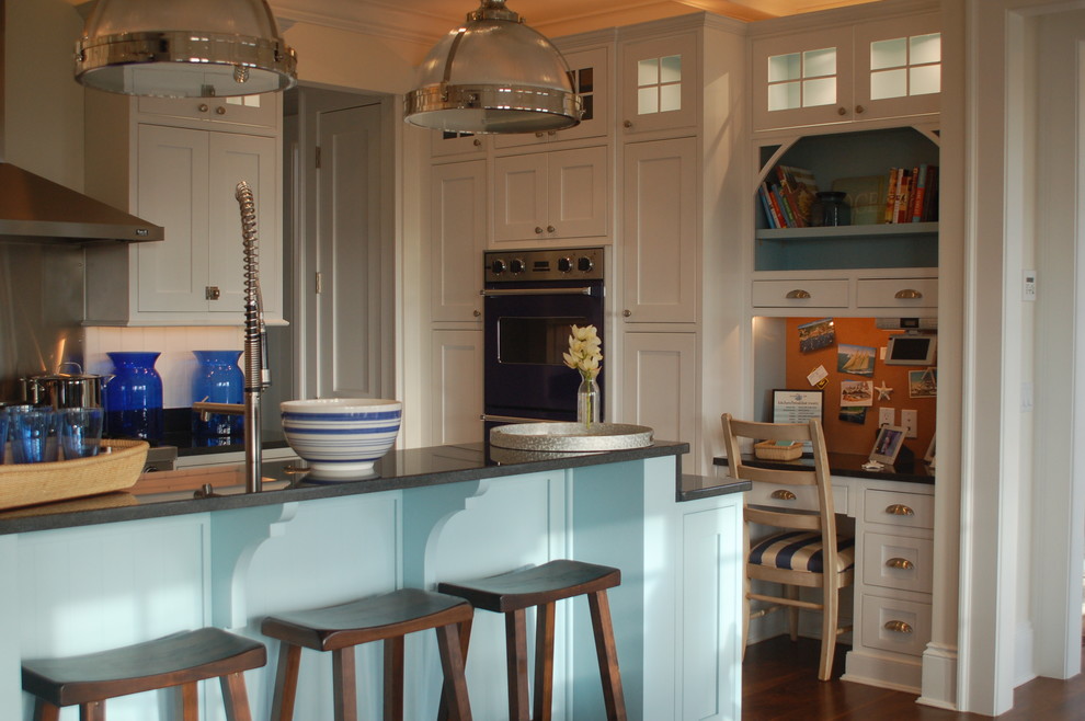 Example of a mid-sized beach style dark wood floor kitchen design in Boston with an undermount sink, beaded inset cabinets, white cabinets, granite countertops, white backsplash, colored appliances and an island