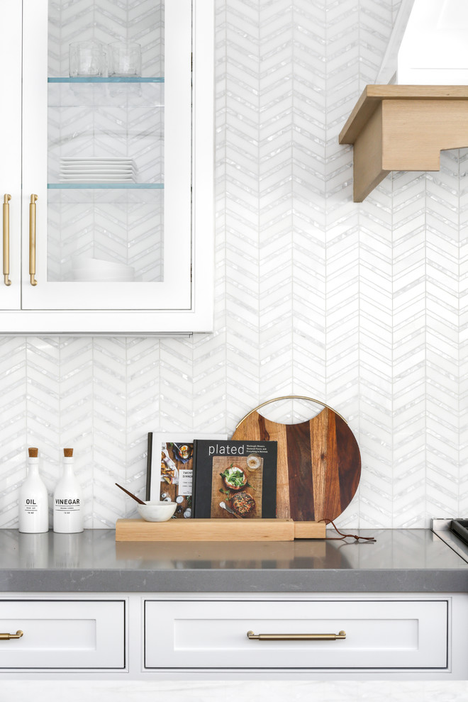 Immagine di una grande cucina minimalista con ante di vetro, ante bianche, top in superficie solida, paraspruzzi bianco, elettrodomestici in acciaio inossidabile, pavimento in legno massello medio e pavimento grigio