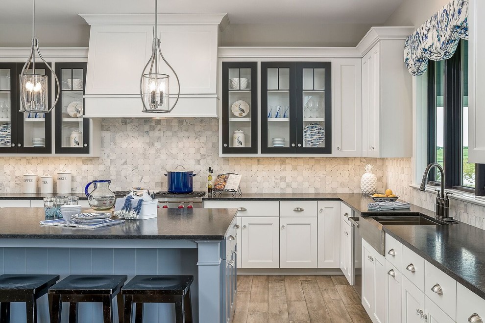 Mid-sized beach style l-shaped dark wood floor and beige floor eat-in kitchen photo in Chicago with shaker cabinets, white cabinets, soapstone countertops, gray backsplash, marble backsplash, stainless steel appliances and an island