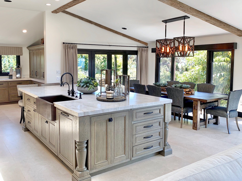 Tuscan l-shaped limestone floor and beige floor open concept kitchen photo with a farmhouse sink, recessed-panel cabinets, gray cabinets, quartzite countertops, beige backsplash, ceramic backsplash, black appliances, an island and beige countertops