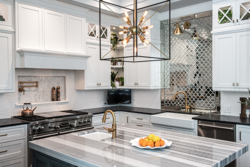 Mid-sized transitional u-shaped kitchen photo in Tampa with a farmhouse sink, flat-panel cabinets, white cabinets, marble countertops, mirror backsplash, stainless steel appliances and an island