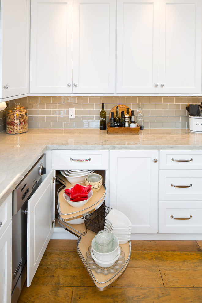 Large transitional u-shaped medium tone wood floor eat-in kitchen photo in San Luis Obispo with shaker cabinets, white cabinets, quartzite countertops, an island, an undermount sink, glass tile backsplash, stainless steel appliances and beige backsplash